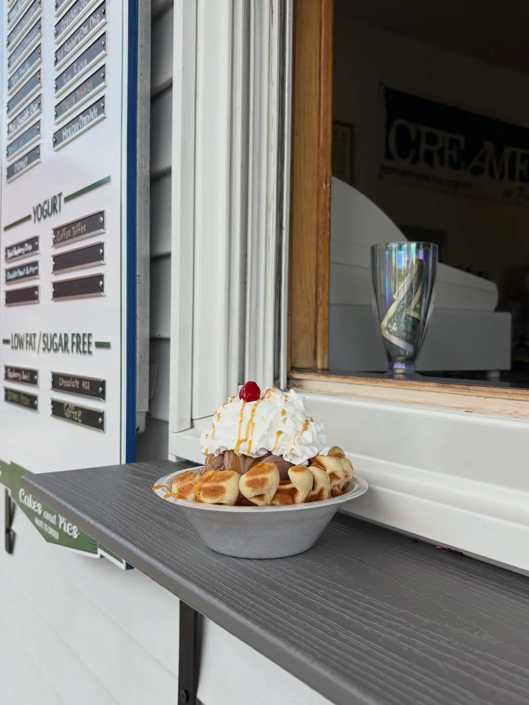 A waffle sundae waiting on the window ledge